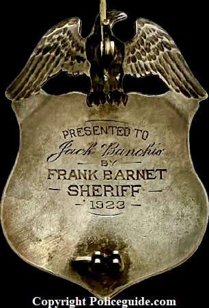 Back of Alameda Co. Deputy Sheriff eagle top shield, Presented to Jack Banchio by Frank Barnet Sheriff 1923.  Sterling silver with hard fired blue enamel