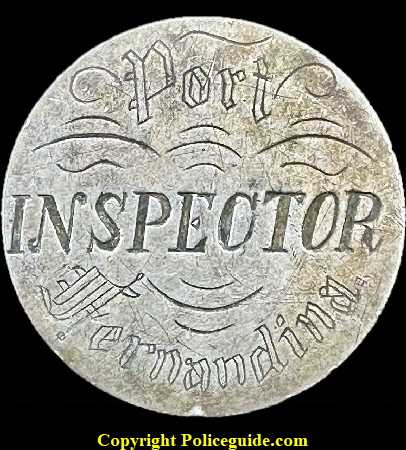 Inspector Port Fernandina badge made from a 1886 Morgan Silver Dollar. The Port is located in Nassau County Florida. Inspector Port Fernandina badge made from a 1886 Morgan Silver Dollar. The Port is located in Nassau County Florida.