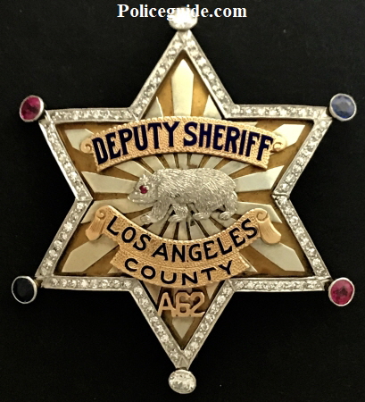 Arthur K. Bournes 14k gold Los Angeles Co. Deputy Sheriff badge adorned with 98 diamonds, 2 saphires and 2 rubies.  Presented to him by Wm. I. Traeger Sheriff Los Angeles.  Arthur K. Bourne was heir to the Singer Sewing Machine fortune and friend of law enforcement.