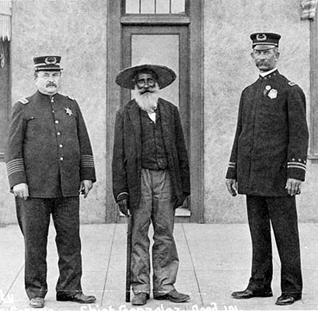 Circa 1911: Captain Moriarty standing with Antonio Gonzales who was the Chief of the 1838 Mexican Town Police and standing on the right is Chief Keno Wilson.