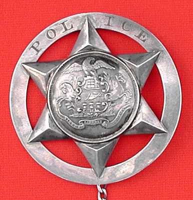 Police badge presented to Jacob Eriq. Police badge presented to Jacob Eriq.