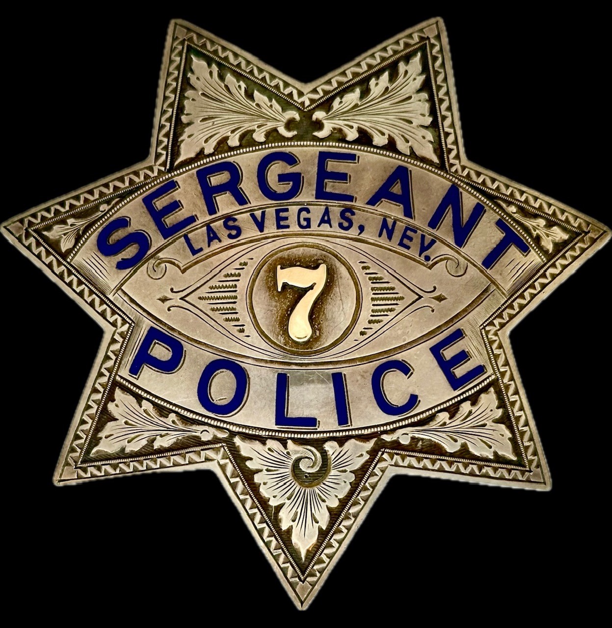 City of Las Vegas Police Sergeant badge #7, worn by Archie Wells, made of sterling silver  by Irvine & Jachens S. F.  and has the International Jewelry Workers Union No. 64 stamp.