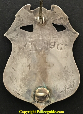 Reverse of badge showing Ed. Jones 906 Broadway Oakland hallmark.  Stamped sterling.