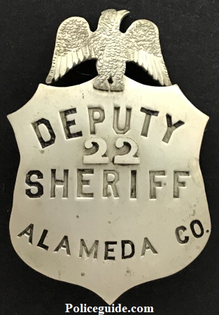 Eagle top shield with applied numbers.  Nickel silver.