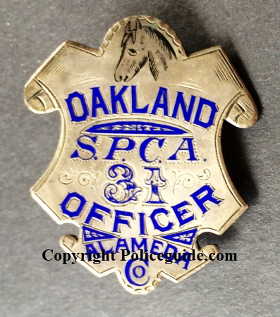 Alameda Co. Oakland SPCA Officer, #31, sterling silver, hand engraved. Hallmarked Morton Jeweler Co. Oakland, CA.  George Fake was now working for Morton and you can see his signature enameled engraving.