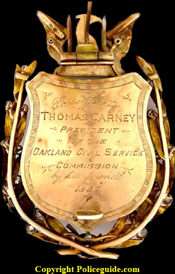 Back of badge showing presentation:  Presented to Thomas Carney - President of the Oakland Civil Service Commission - by his friends.  1927.