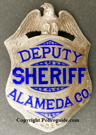 Alameda Co. Deputy Sheriff, sterling silver, hand engraved. Made by Oakland Jeweler and watchmaker George Fake.  Noted Alameda County historian and collector James Bolander advised me that this badge is the first deparment issue and that after the deparment went to a new style, these badges were numbered and issued to Special Deputies.