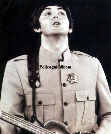 Paul McCartney at Shea Stadium wearing his Wells Fargo badge.