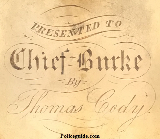 Reverse of Chief Martin Burke�s badge showing the presentation.  