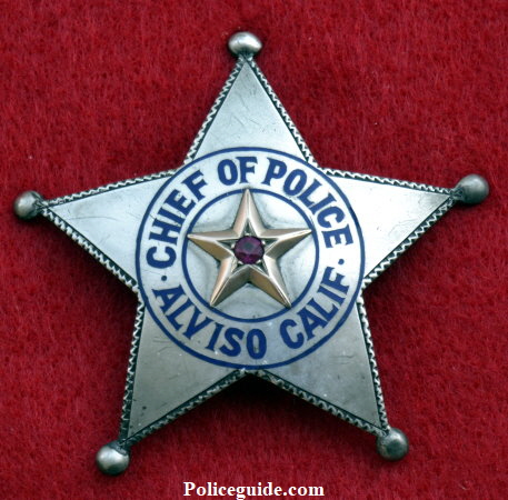 Chief Bacigalupi was not impressed with the badge and wanted one more fitting to his office. Some time in 1921 he was presented with the sterling silver badge shown above right. However, before the presentation was made the Mayor and friends of the Chief presented him with an enormous badge adorned with a bicycle refector in the center as a joke. See picture below. Chief Bacigalupi was not impressed with the badge and wanted one more fitting to his office. Some time in 1921 he was presented with the sterling silver badge shown above right. However, before the presentation was made the Mayor and friends of the Chief presented him with an enormous badge adorned with a bicycle refector in the center as a joke. See picture below.