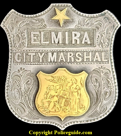 Elmira City Marshal presentation shield made of sterling silver and adorned with 18k gold seal and 5 point star.