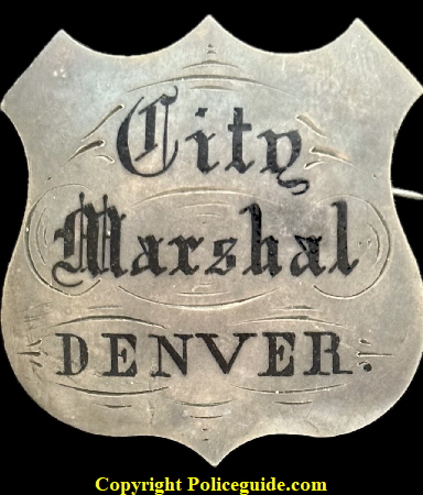 Denver City Marshal shield made of sterling silver with hard fired black enamel.  Jeweler made.  Worn by David Cook who served from 1866 to 1869