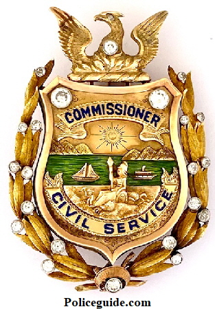 14k & 18k gold Civil Service Commissioner badge with beautiful green enamel representing the San Francisco Bay and adorned with 22 diamonds.  The badge was presented to Thomas Carney in 1927.