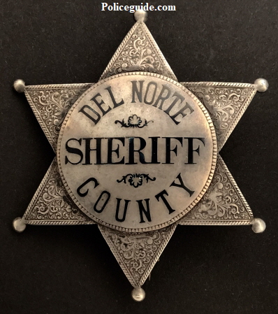 Early Sheriff’s badge made of sterling silver with hard fired black enamel.