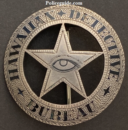 Hawaiian Detective Bureau.  Sterling silver with hard fired black enamel.