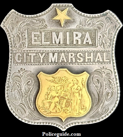 Elmira City Marshal presentation shield made of sterling silver and adorned with 18k gold seal and 5 point star.