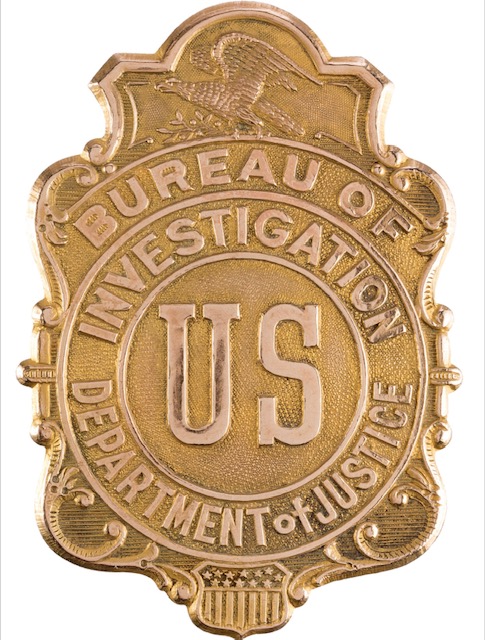 Bureau of Investigation US Department of Justice shield.   It appears to be gold-plated brass and is stamped on the back "Whitehead & Hoag Newark, N.J. Gold Filled" and "553". An eagle appears at top and a shield at the bottom. The background is stippled. Superb detail throughout. It has a C-type pin attachment on the verso. This type of badge saw use between 1908 and 1927. The Bureau of Investigation later became the Federal Bureau of Investigation (F.B.I.) beginning in 1935.