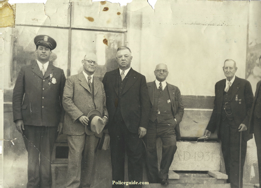 Chief Louis Silva wearing his sterling silver Chief of Police badge and his Distinguished Service Cross is posing with other Veterans.