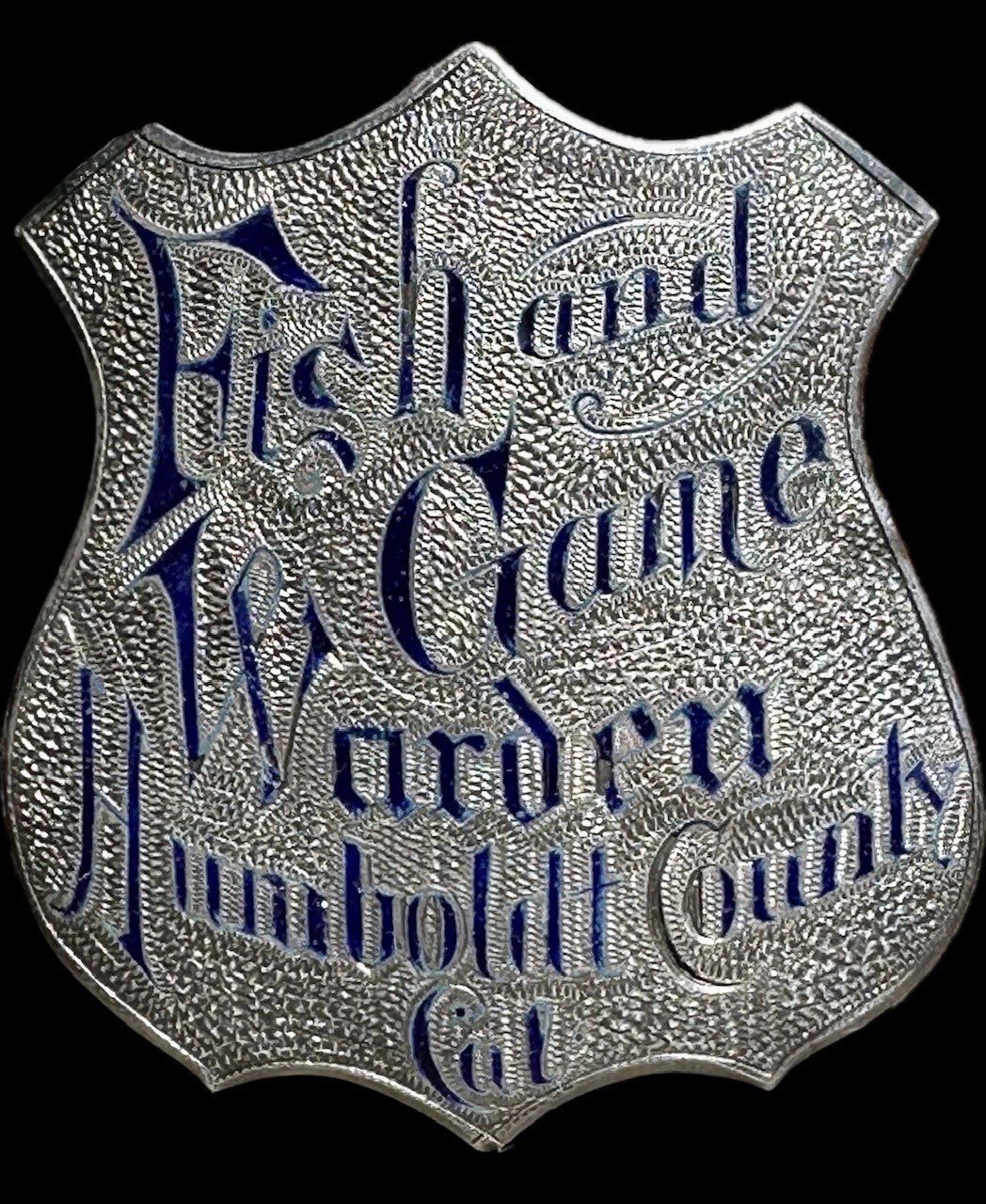 Humboldt County Fish and Game Warden shield, made of sterling silver with hard fired blue enamel lettering.  The enamel work is exceptional and the jeweler reinforced the back of the badge to insure the badge did not flex and pop out the enamel.