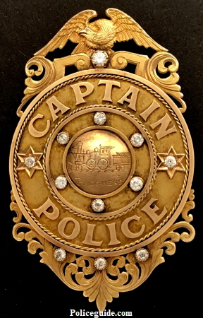 Gold presentation badge, presented to George M. Brown Captain of Police Louisville Police Department.