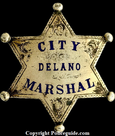 Delano City Marshal star made of sterling silver, hand engraved.  Lettering has hard fired bllue enamel.  Hallmarked Chipron Stamp Co. L. A. Cal.