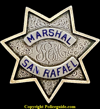 Personal badge of John E. Healy, the 1st City Marshal of San Rafael in 1893.  Made by DWL S.F.  JEH is engraved in the center, the badge is Sterling Silver with a 18k gold raised border.  Healy was also the first Chief of Police when the title was changed from City Marshal.  He was born in 1851 in New York and died January 22, 1920.  In the San Rafael City Directory of 1901 he was still listed as Marshal.  He was a brother of Frank Healy of Marin County  a former Sheriff.