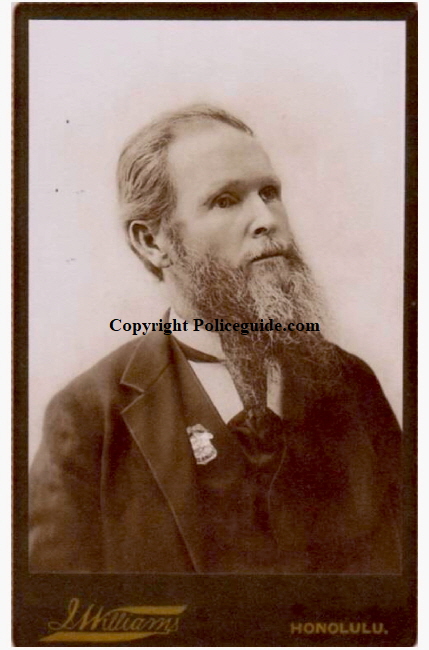 Marshal Hitchcock portrait wearing his 14k gold Marshal of the Hawaiian Islands badge.