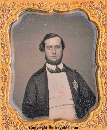 Daguerreotype of Boston Police officer wearing the 1st issue shield, issued in 1853.