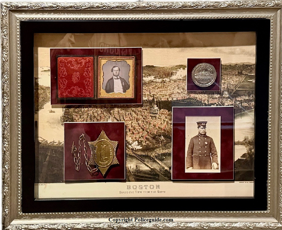 Boston Police display with a 1st issue and 5th issue badge with photos of officeres in uniform.