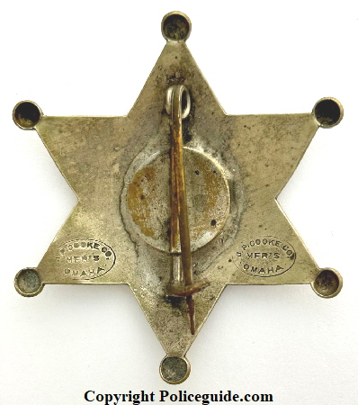 Back of Norfolk Nebraska Police badge No. 22 made by J. P. Cooke Co. Mfgs Omaha, NEB.