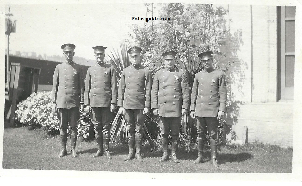 Bert Lundy standing center with four other National Guard members who are all wearing badges.