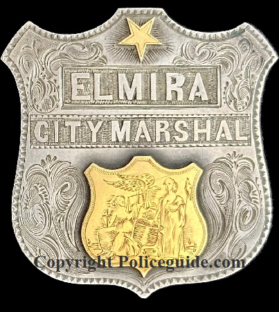 Elmira City Marshal presentation shield made of sterling silver and adorned with 18k gold seal and 5 point star.