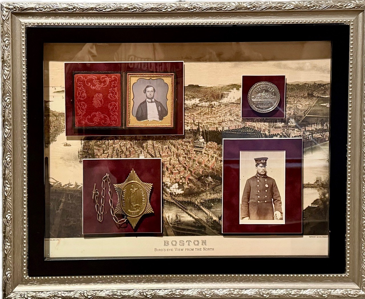Boston Police display with a 1st issue and 5th issue badge with photos of officeres in uniform.