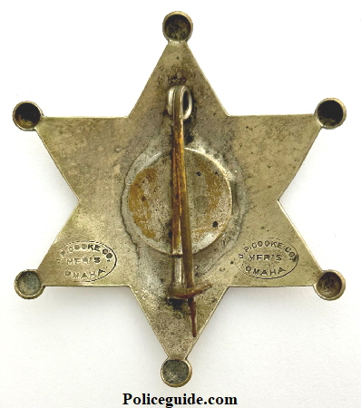 Back of Norfolk Nebraska Police badge No. 22 made by J. P. Cooke Co. Mfg’s Omaha, NEB.