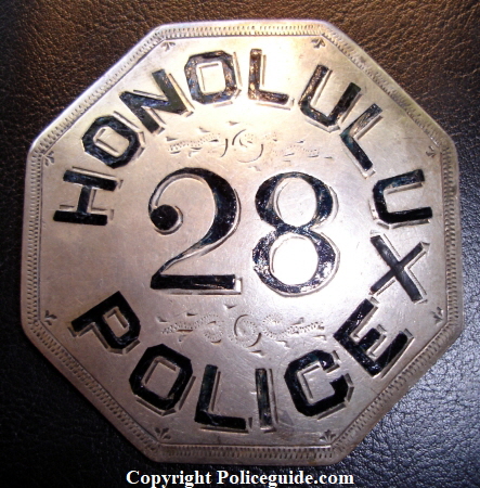 Honolulu Police badge #28 and crossed oars.  Sterling silver with hard fired black enamel.