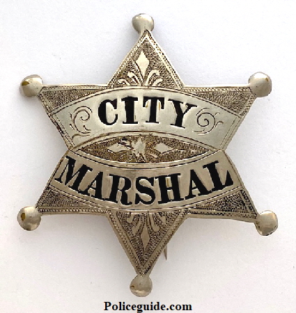 Last City Marshal badge worn in Petaluma before the title was changed to Chief of Police.  Worn by E. A. Husler.