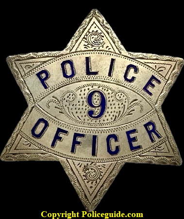 Reno Police badge No. 9, made of sterling silver with hard fired blue enamel.