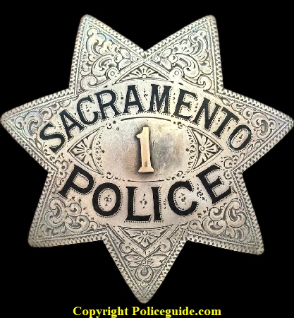 Sacramento Police star No. 1, made of sterling silver and having an applied gold numeral placed in the center, surrounded by hand engraving and hard fired black enamel lettering.  Hallmarked Ed Jones Co. Oakland, CAL