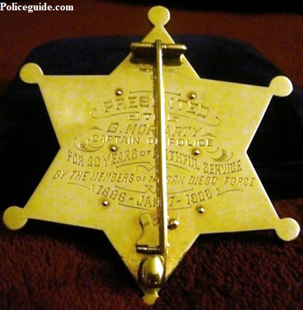 Reverse of gold presentation badge.