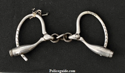 Henry Gaylords nickel plated handcuffs hallmarked Marlin Firearms Company, with key.