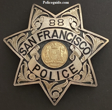 S.F.P.D. Prototype Badges.  Back in the 1970’s it was felt by the department that they should explore going to a more unique police badge.  Irvine & Jachens was tasked with coming up with new designs for consideration.  These three prototype’s were considered.  Badge number 88 was the badge number assigned to officer Russ Dickey.   Russ was issued the badge to wear on duty and seek opinions and feedback from fellow officers and the public.  Both badges 88 and 123 are sterling silver with hand engraved leafing highlighted by recessed black enamel.  Badge 0000 was a departure from the 7 point star worn for more than 100 years.  The badge featured reverse blue enameled panels and borders and a sterling silver city seal.  Tradition won out and it was decided no change would be made.  To this day badge 88 worn by Russ Dickey is the only department authorized prototype badge to be worn.