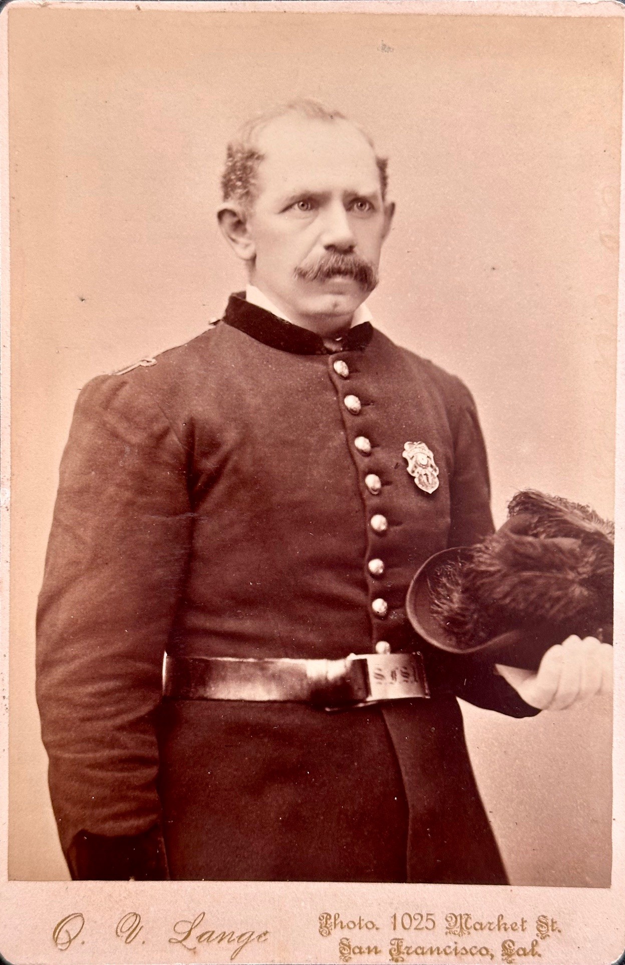 Cabinet card image by O. V. Lange, 1025 Market St. San Francisco, CAL with a proud owner of Schuetzen Verein badge No. 1.