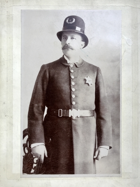 San Jose Police officer wearing 1st issue badge No. 1.