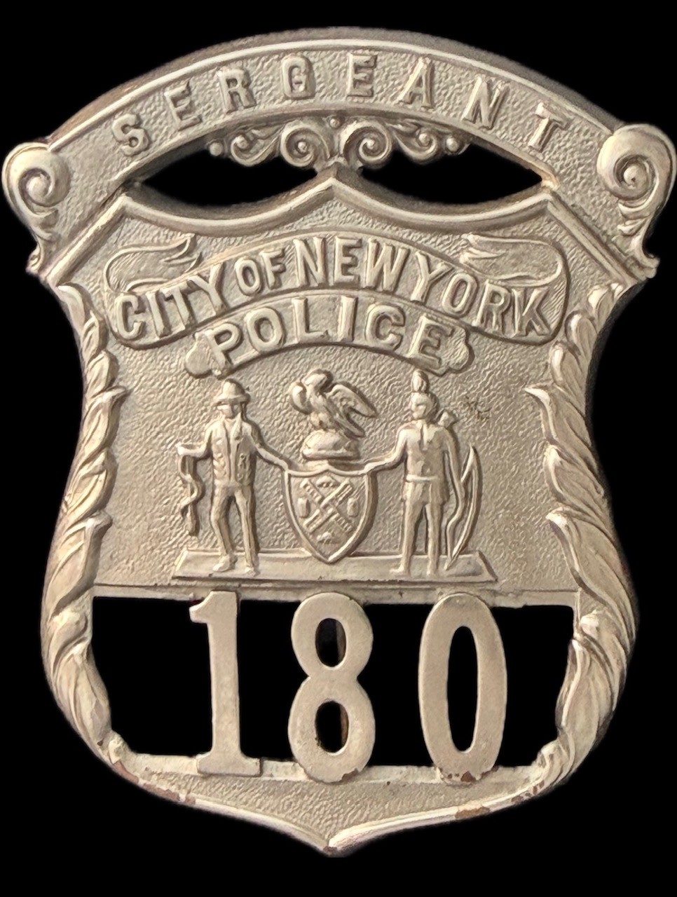 1903 issue of the NYPD Sergeant shield referred to as the Type 1, later changed to a gold color shield known as the Type 2. 1903 issue of the NYPD Sergeant shield referred to as the Type 1, later changed to a gold color shield known as the Type 2.