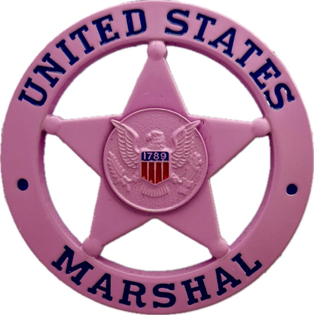 United States Marshal circle star badge in pink.  Personal badge of “Uncle Budd” Johnson who rose to the rank of Inspector with the Marshal’s Service.  He was well known as an expert on Outlaw Biker Gangs and provided training for law enforcement agencies in the U.S.A., Canada and the United Kingdom.  He has been featured in T.V. documentaries and mentioned in numerous books on the U. S. Marshals.  R.I.P.