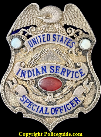 United States Indian Service Special Officer, sterling silver, eagle top shield adorned with three semi precious stones.  Hallmarked Irvine W. & Jachens 2129 Market St. S.F.  This mark was used from 1907-1909.